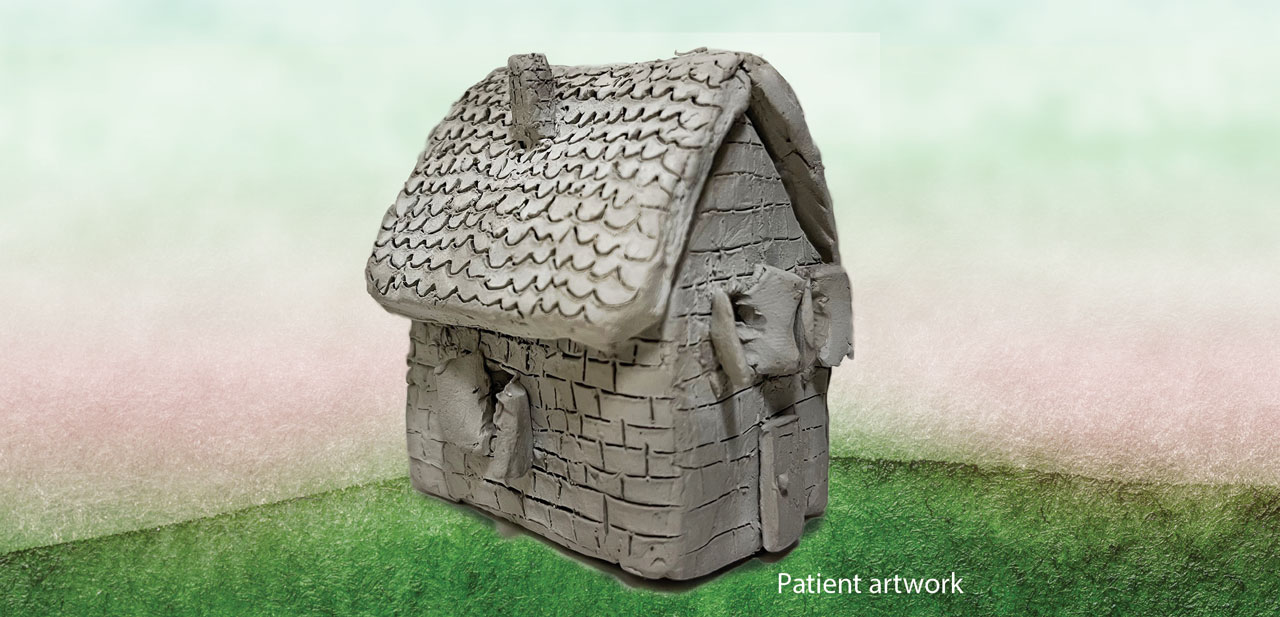 Photo of small clay house made by a patient