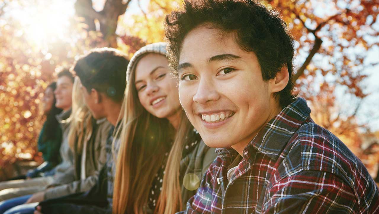 Photo of teens enjoying a sunny, autumn day