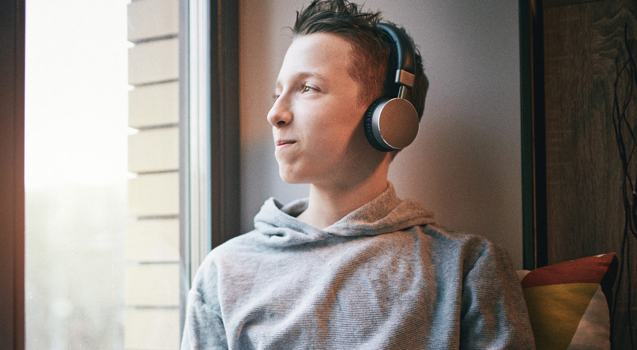 Teen listening to music on headphones