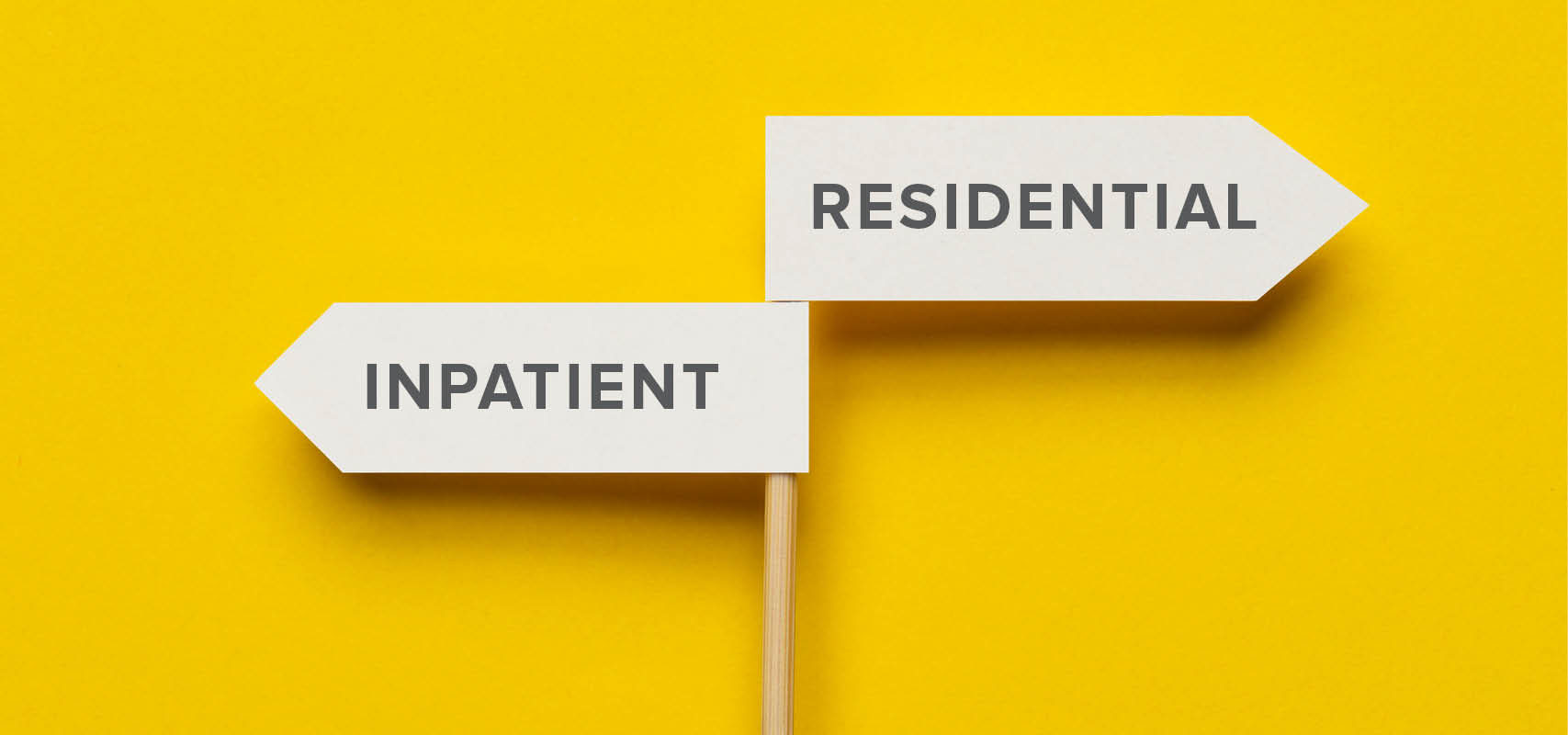 Photo illustration of a sign pointing in opposite directions with the choices for Inpatient or Residential care
