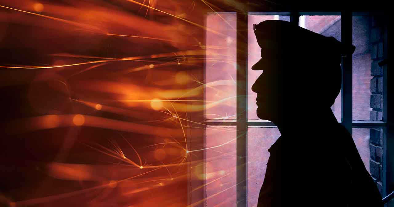 photo of a corrections officer in silhouette superimposed over flames representing stress