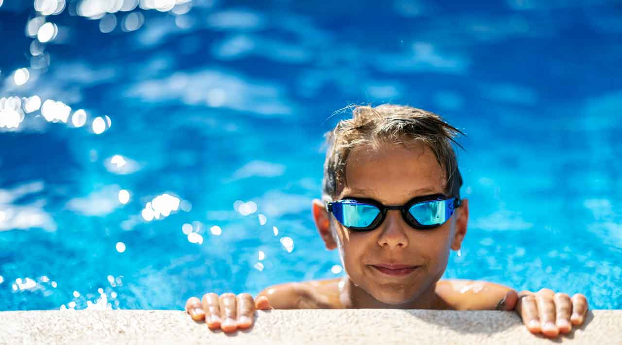 photo of kid on the edge of a swimming pool