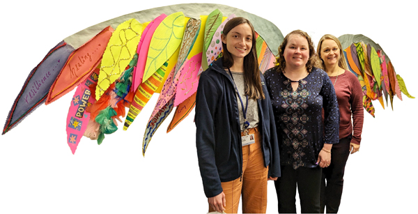 Pictured with the wings  project are (left to right) Danielle Andersen, Jacqueline Pidich, and Jamie Benjamin. Patient art shared with patients' permission.