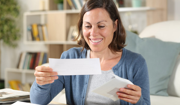 Photo of happy woman getting mail