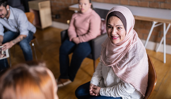 Photo of muslim woman in group therapy