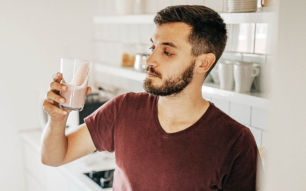 Image of young man drinking shake beverage