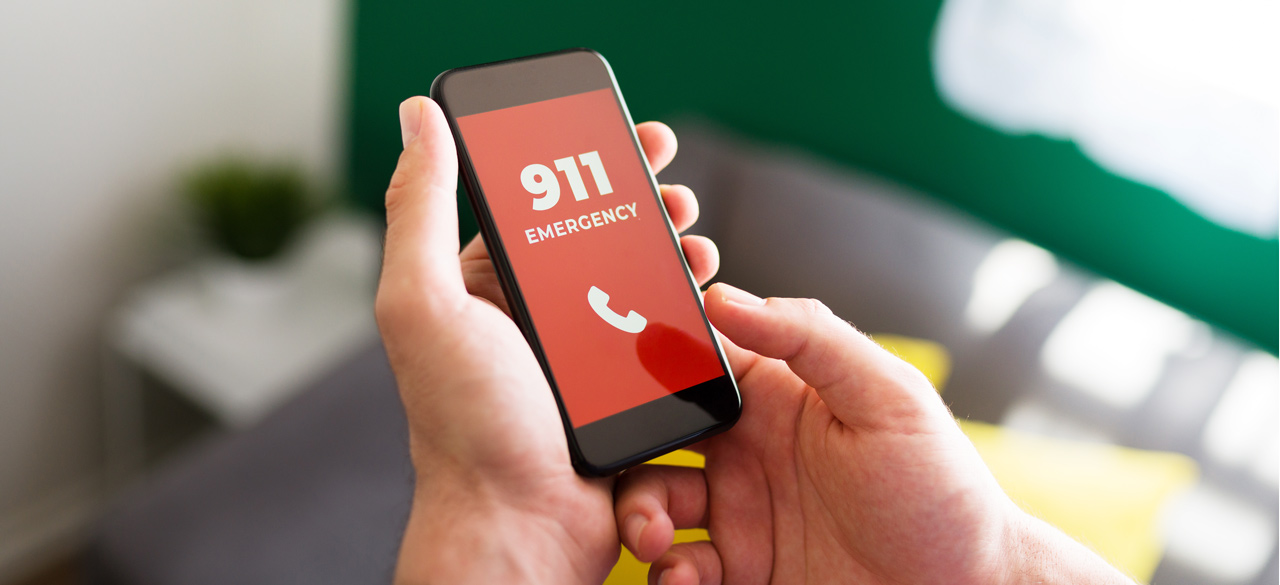 Photo close up of hand dialing 9-1-1 on a smart phone