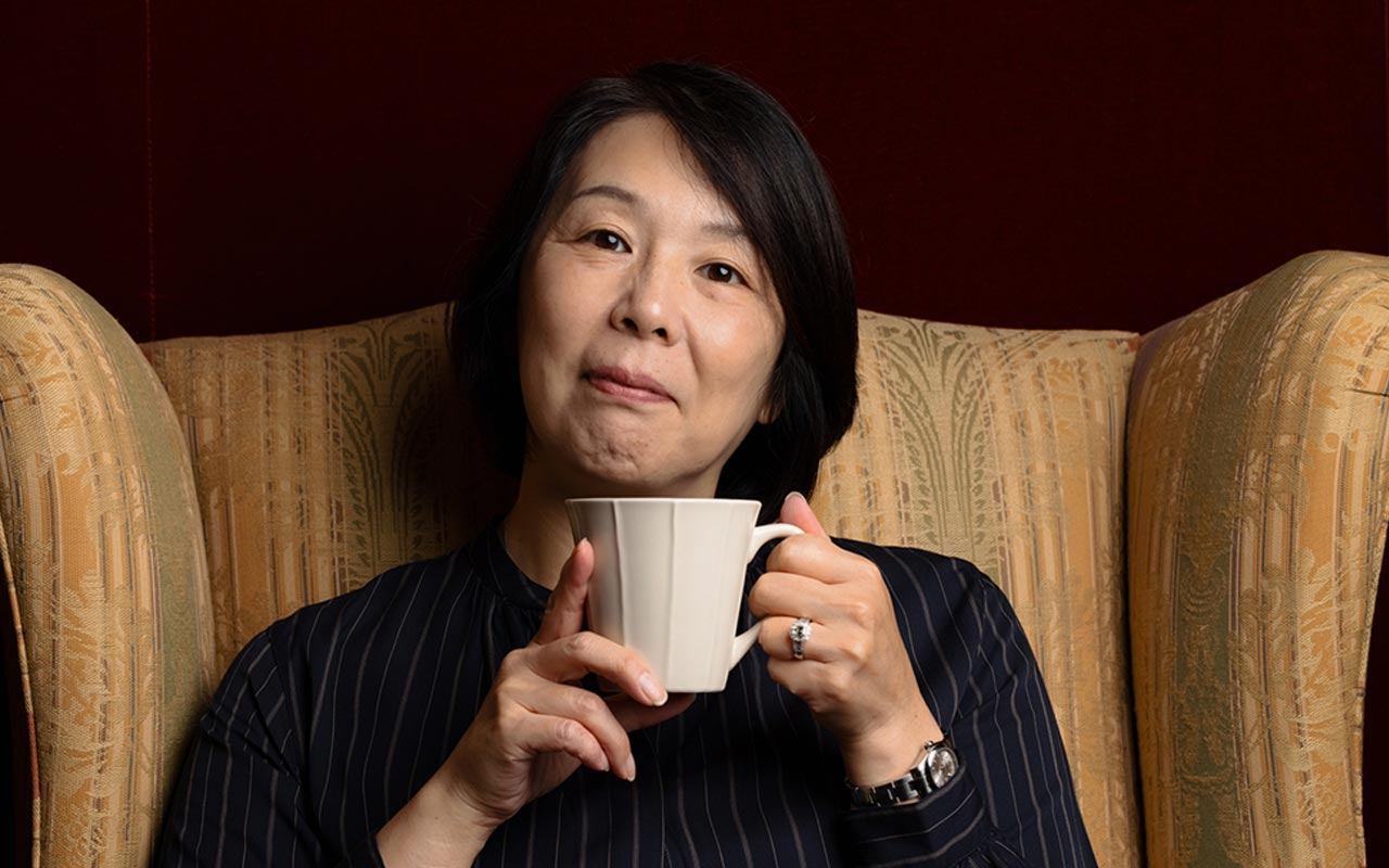 Image of woman holding tea cup and looking puzzled