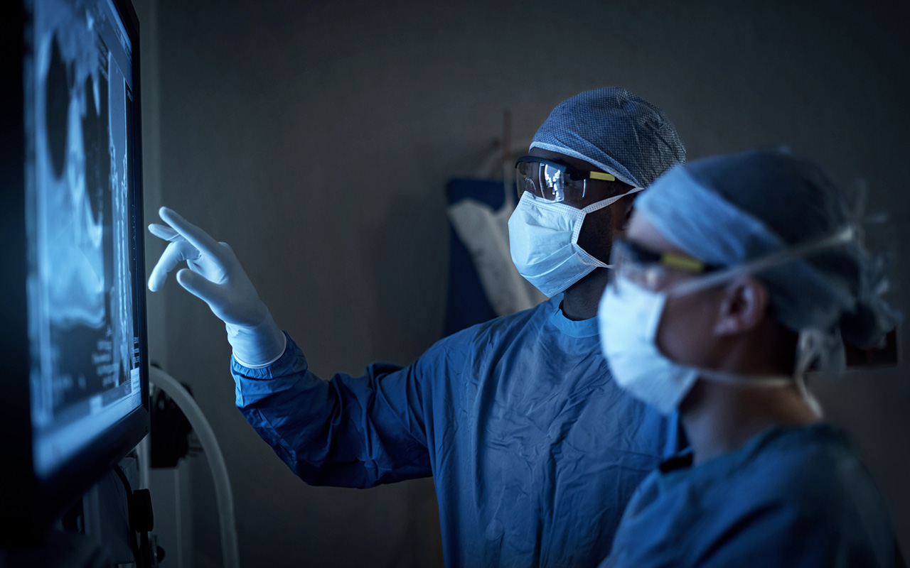 Image of surgeons looking at xrays