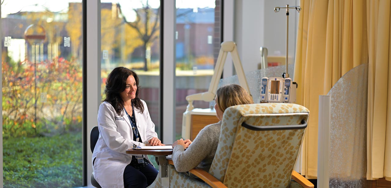 photo of clinician talking with patient at Princeton Medical Center's infusion center