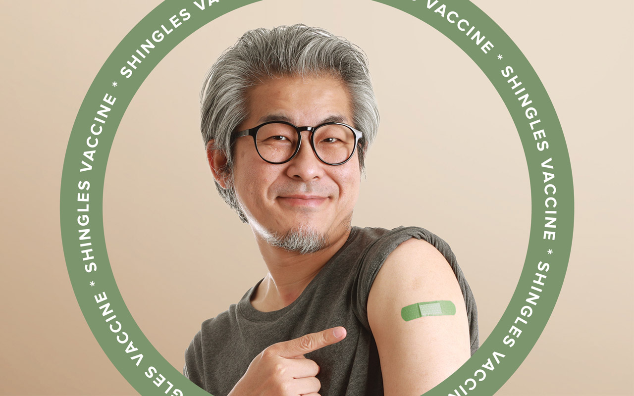 Image of man proudly showing that he got the shingles vaccine
