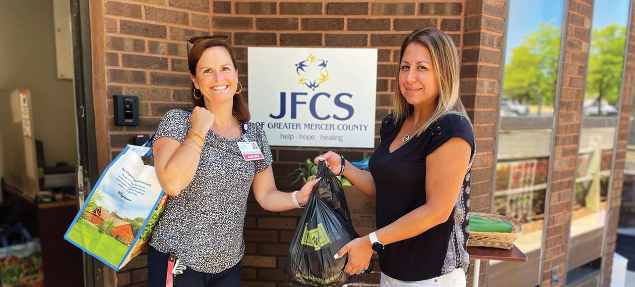 Pictured above, left to right: Catherine Eldridge, Princeton Health Community Health Navigator, accepts groceries from Lorena Morales, Jewish Family and Children Services of Mercer County’s Program Assistant for Counseling & Hunger Prevention.